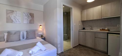 a white bedroom with a bed and a sink at House Kiriaki in Sarti