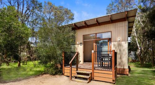 a small house with a porch and a balcony at The Point Villa in Cowes