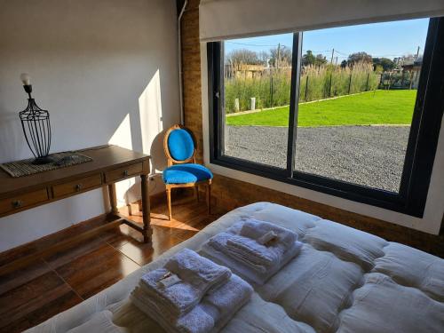 a bedroom with a bed and a desk and a window at Don Vito Casa de Huespedes in Cucullú