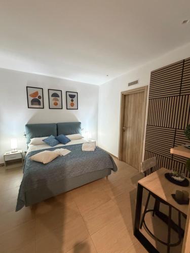 a bedroom with a large bed and a table at Casetta Villabate in Villabate