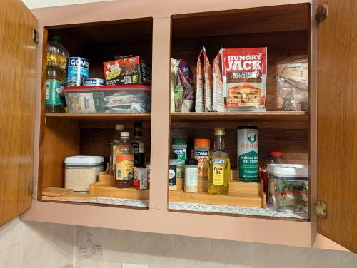 a cabinet filled with lots of food and spices at Sun Seekers Retreat 3 bedrooms in Santa Maria