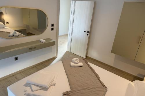 a room with a mirror and a bed with a towel at Apartments Villa Nikola- one minute to the beach in Gradac