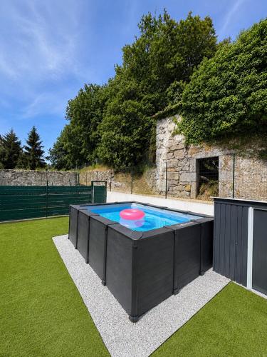 a pool with a frisbee on top of it at Casa das Abelhas in Arcos de Valdevez