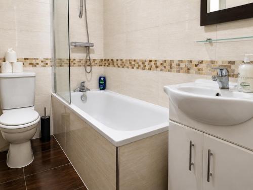 a bathroom with a toilet and a sink at Spacious flat in Streatham in London