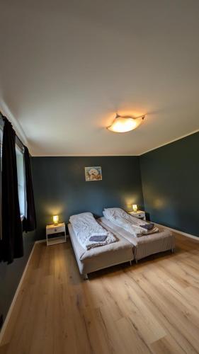 a bedroom with a bed and two lights on the wall at Cozy pet-friendly apartment with parking in Flekkefjord