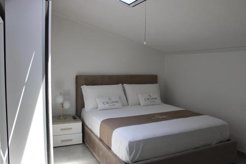 a bed in a white room with a mirror at Cridima Luxury - Villa Hera in Santa Maria La Carità