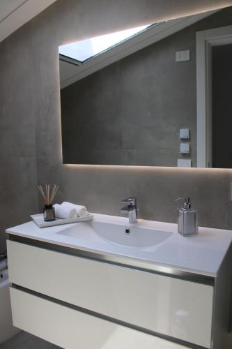 a bathroom with a sink and a large mirror at Cridima Luxury - Villa Hera in Santa Maria La Carità