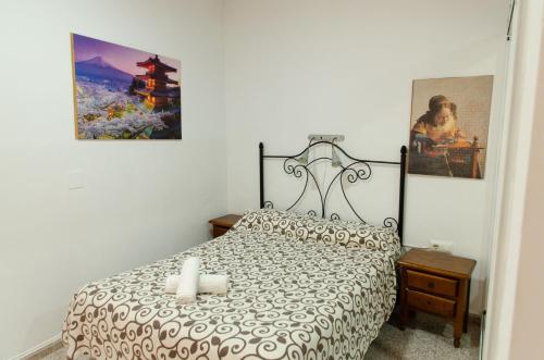 a bedroom with a bed with two candles on it at Hospedaje Lisboa Algeciras P Ca 0214 y A Ca 0232 in Algeciras