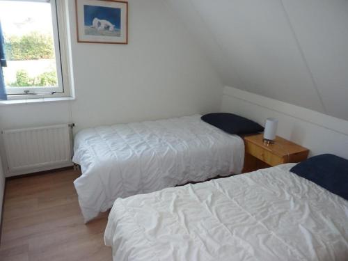 a room with two beds and a window at Bungalow in Breskens near Beach & Lighthouse in Breskens
