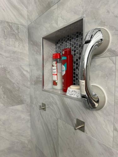 a bathroom with a shelf with a faucet at Quiet room in a family home in Lehigh Acres