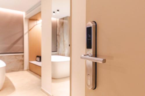 an open door to a bathroom with a toilet at Nuna Hotel & Apartments in Vlorë