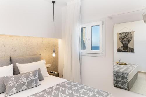 a bedroom with a bed and a window at Pyrgaki Hideout Beachfront Apartment in Agiassos