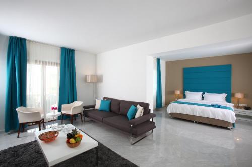 a hotel room with a bed and a couch at saraya otel in Bodrum City
