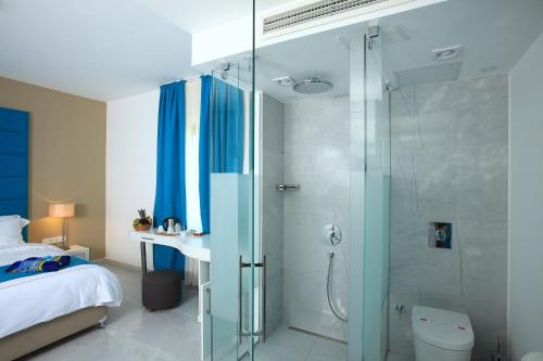 a bathroom with a shower and a toilet and a bed at saraya otel in Bodrum City