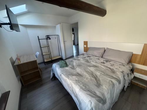 a bedroom with a large bed in a room at La maison Sophel in Pieris