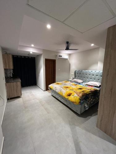 a bedroom with a bed in the middle of a room at Cloud Eleven House in Kharar