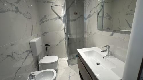 a bathroom with a sink and a toilet and a shower at La maison Sophel in Pieris