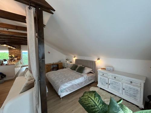 a bedroom with a bed and a dresser at U zlatého křížku in Loukov