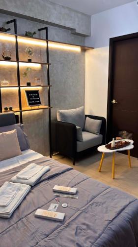 a bedroom with a bed and a chair and a table at Ciao Vacanza Staycation in San Fernando