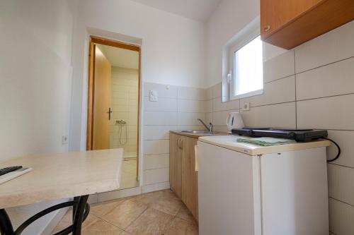 a small kitchen with a sink and a dishwasher at FIRST ROW Sea View in Šušanj