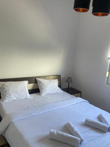 a large white bed with two towels on it at Apartman Teodora in Risan