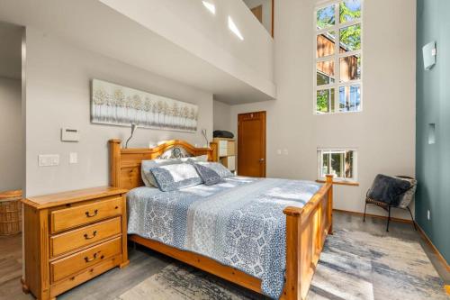 a bedroom with a bed and a dresser and a window at Dash Point Modern in Tacoma
