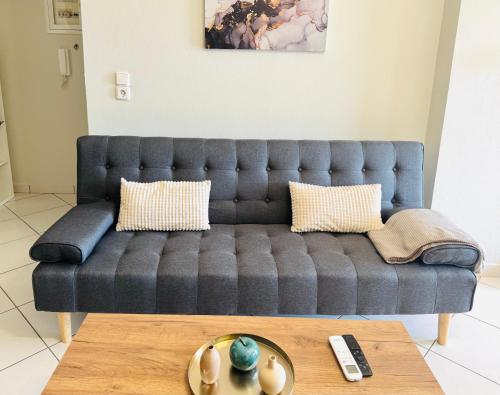 a blue couch in a living room with a coffee table at Casa Panorama in Igoumenitsa