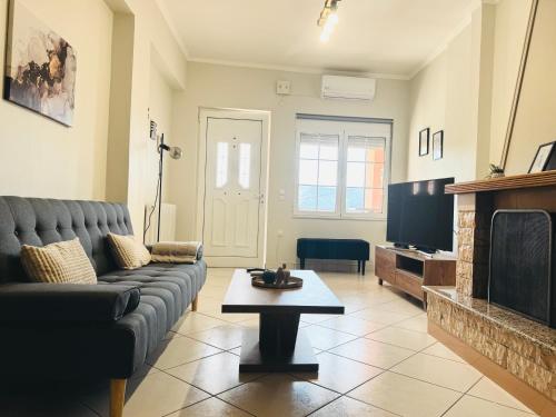 a living room with a couch and a fireplace at Casa Panorama in Igoumenitsa