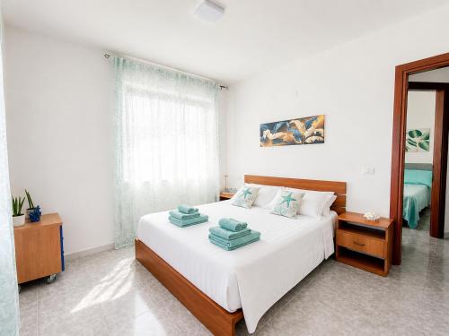 a bedroom with a bed with towels on it at Center Room Tortolì wifi, AC, free parking, city center at 100 m in Tortolì