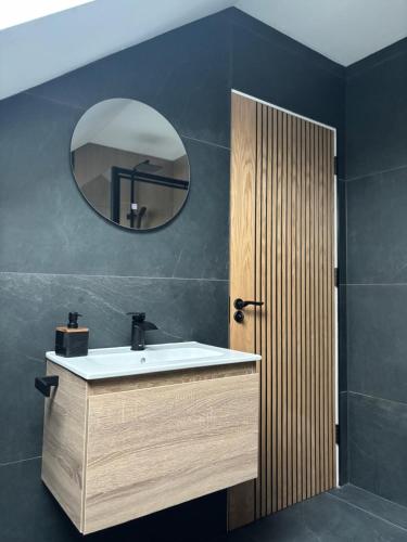 a bathroom with a sink and a mirror at Skellig Bliss in Valentia Island