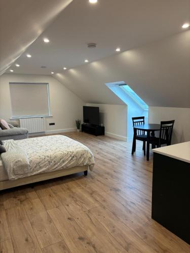 a bedroom with a bed and a table and a screen at Skellig Bliss in Valentia Island