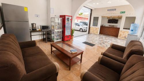 a living room with two couches and a coffee table at Hotel King del Centro San Miguel in San Miguel