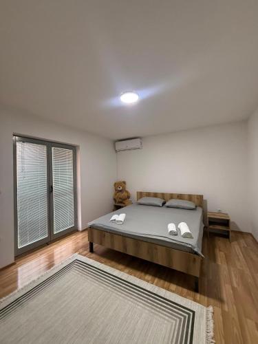 a bedroom with a bed and a large window at DrimResidence in Struga