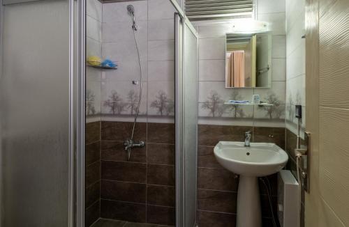 a bathroom with a shower and a sink at Karacan Hotel - Dalaman Airport in Dalaman