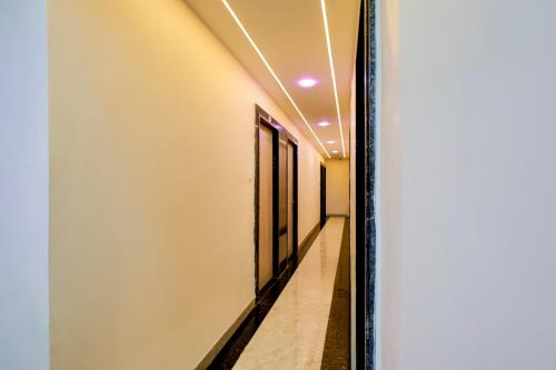 a mirror in a hallway with a corridor at Hotel O Eleven in Jabalpur