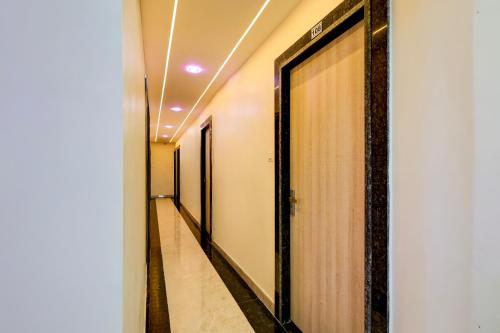 a row of elevators in a corridor in a building at Hotel O Eleven in Jabalpur