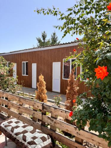 a wooden building with a bench in front of it at Tamchy Residents in Tamchy