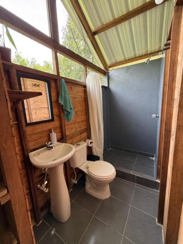 a bathroom with a toilet and a sink at Pal Mar in Nuquí