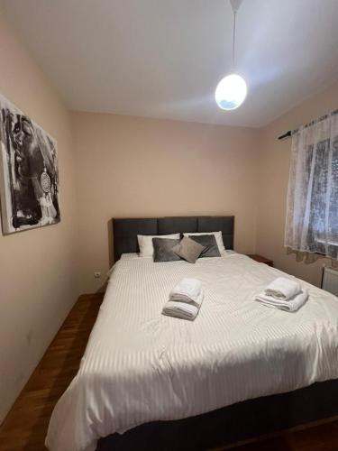 a bedroom with a bed with two towels on it at River House Batrovci in Batrovci