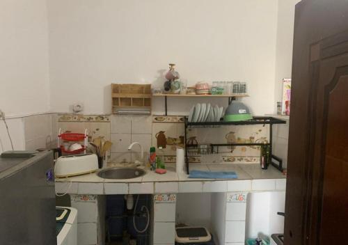 a kitchen with a counter top with a sink at Brise de Mer Azur in Djibouti