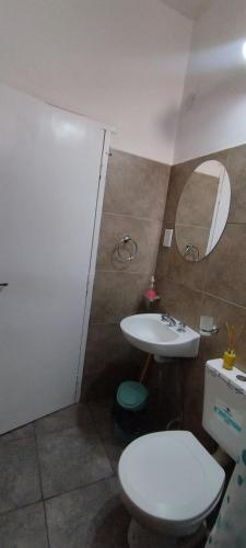 a bathroom with a toilet and a sink at Alojamiento DON ANTONIO in Tinogasta