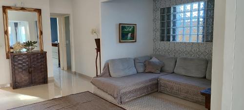 a living room with a couch and a window at Casa na Grande Florianopolis in Palhoça