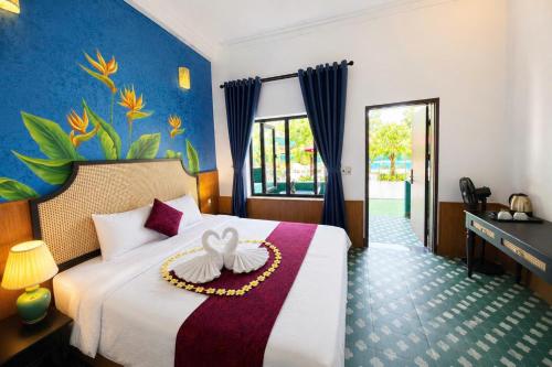 a hotel room with a bed with a flower on it at Minh Chau Beach Resort in Quang Ninh