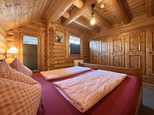 a bedroom with two beds in a wooden cabin at Bavaria in Teunz