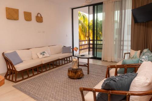 a living room with two couches and a table at Villas Aakal Petirojo in Chicxulub