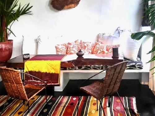 a living room with a table and a couch at Tribal Hotel in Granada
