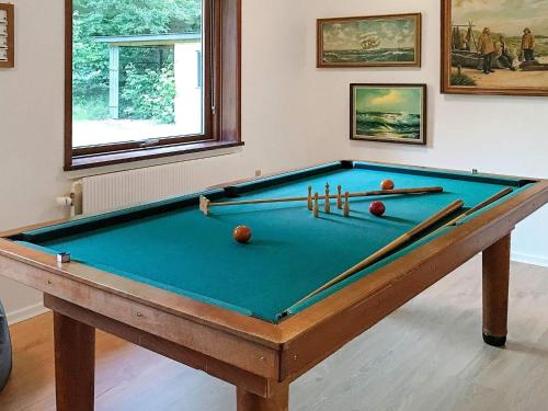 a pool table with balls and bats in a room at 6 person holiday home in Nykøbing M in Hesselbjerg