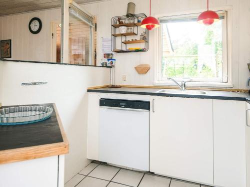 a kitchen with white cabinets and a sink at 10 person holiday home in Ørsted in Ørsted