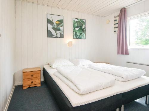 a bedroom with two beds and a window at 10 person holiday home in Ørsted in Ørsted