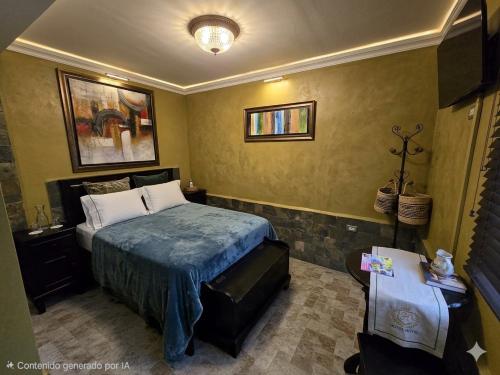 a bedroom with a bed and a table in it at Posada Doña Alcinda in Catia La Mar